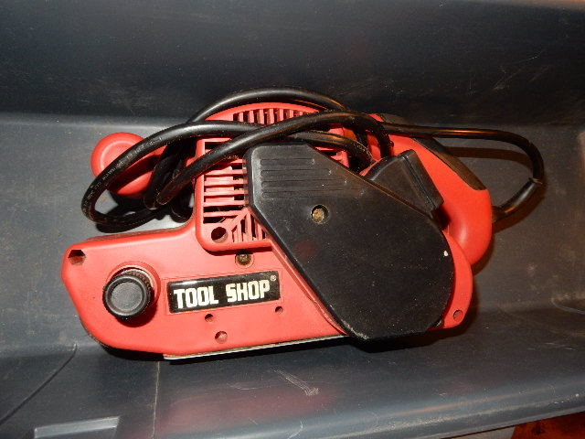 lot 10 image: Tool Shop Belt Sander, Extra Abrasives, Plastic Tool boxcarrying case