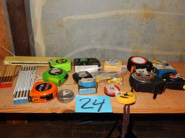 lot 24 image: Large lot of 16ft and smaller tape measures and folding rulers