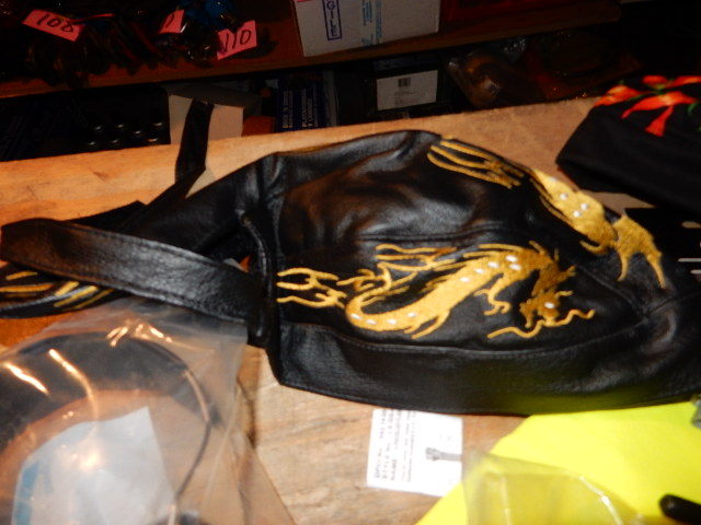 lot 34 image: 1, Ear Protection radio, 1 Ear Protection, 2 Scull Caps (1leather, 1 cloth with peppers).  2 Headset handkerchiefs, First Aid kit, Nike Head band