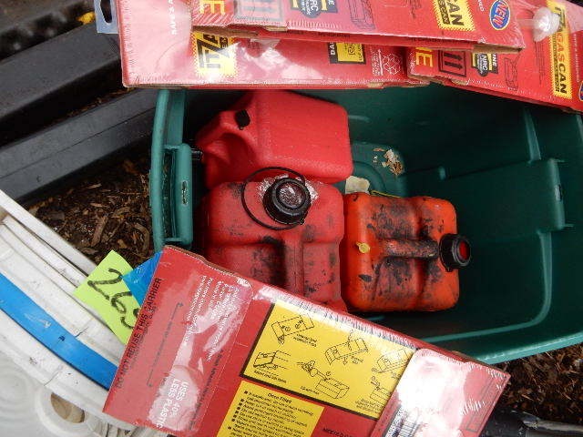 lot 265 image: Plastic gas cans, 5 gal buckets, baricade posts