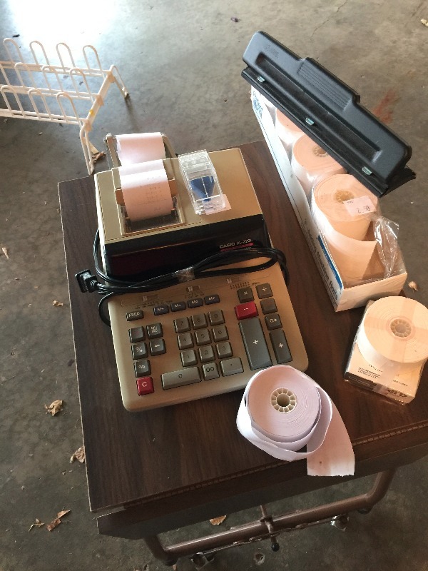 lot 25 image: Typewriter Stand with adding machine, 3-hole punch and paper adding machine tape