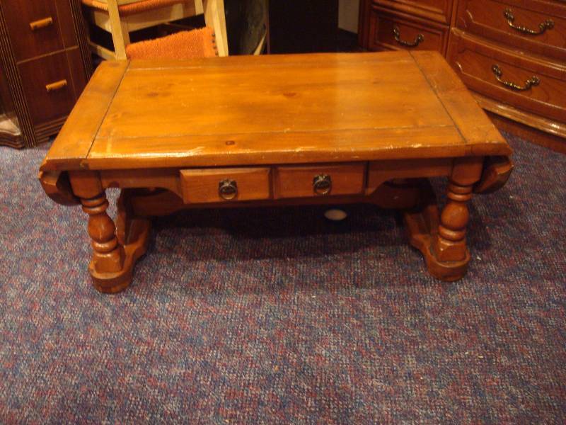 lot 13 image: Wood Coffee Table With Folding Ends. Has Wear...