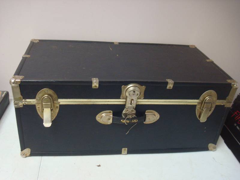 lot 34 image: Black Storage Footlocker Chest. Some Wear....