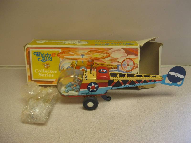 lot 55 image: Whirly Bird Tin Toy...