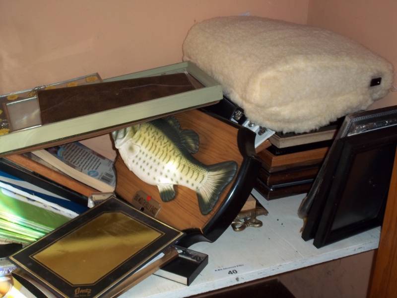 lot 40 image: Shelf of picture frames, singing bass, and misl contents.