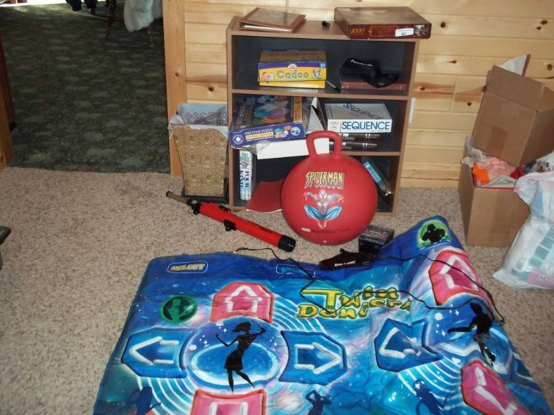 lot 82 image: Dance mat, Telescope, board games, Garbage can, shelf with all contents