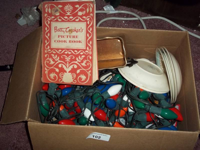 lot 102 image: Christmas dcor light with cookbook and plates