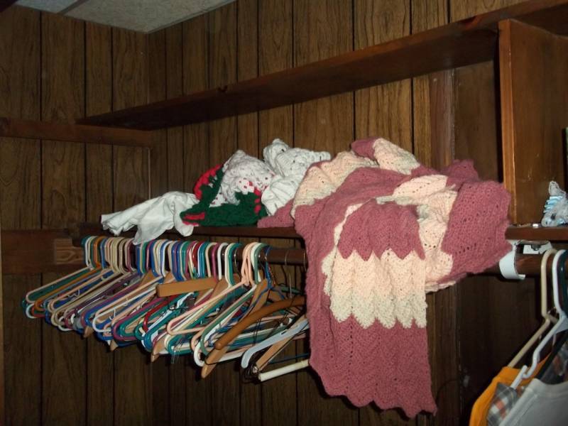 lot 103 image: Closet lot with hanger, knit items and knife