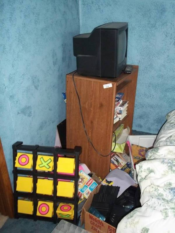 lot 112 image: Kids games, TV with remote, TV stand, racecar tracks.