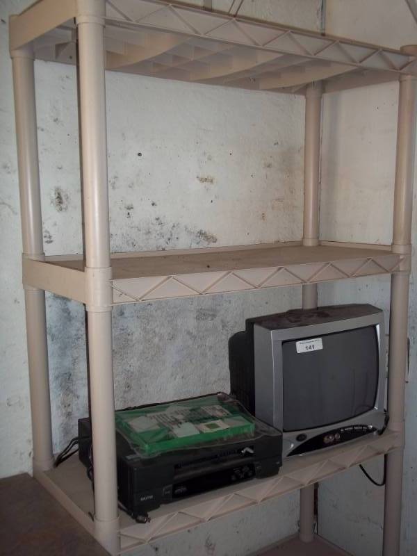 lot 141 image: Plastic shelf with TV and VCR