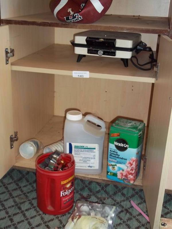 lot 148 image: Shelves with garden chemicals and waffle iron, candles and cookie cutters