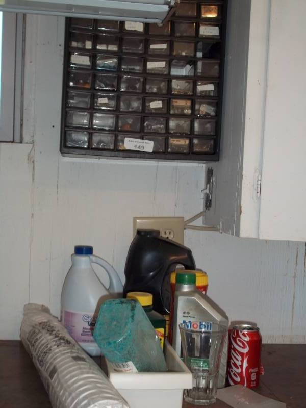 lot 149 image: Lot with wall organizer bleach, garden chemicals  and oil