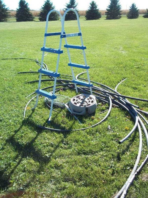 lot 300 image: Lot containing Ladder, Fish Net, Misc PVC hose, etc