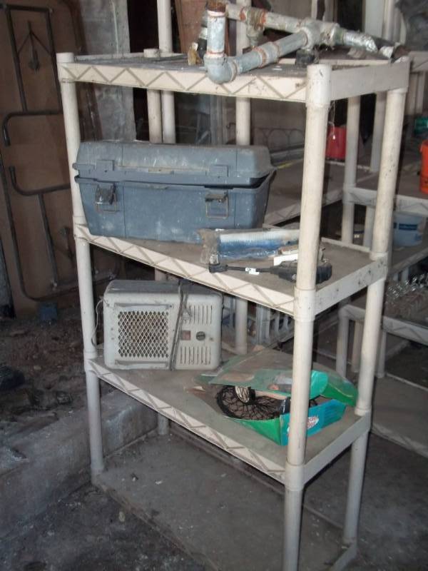 lot 357 image: Plastic shelf with contents and hose winder