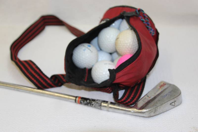 lot 13 image: Wilson Julius Boros putter, bottle Koozie with approx. 12 golf balls
