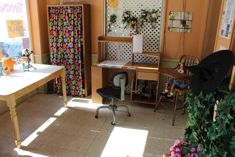 lot 14 image: Front Room Lot Including Wooden Desk Wooden Shelf Wooden High Chair And More Table Cloths Not Included.