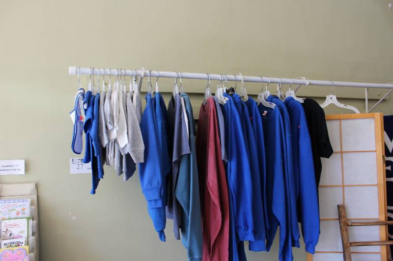 lot 27 image: Rack Lot of Clothing Includes Rack May Require Tools For Removal.