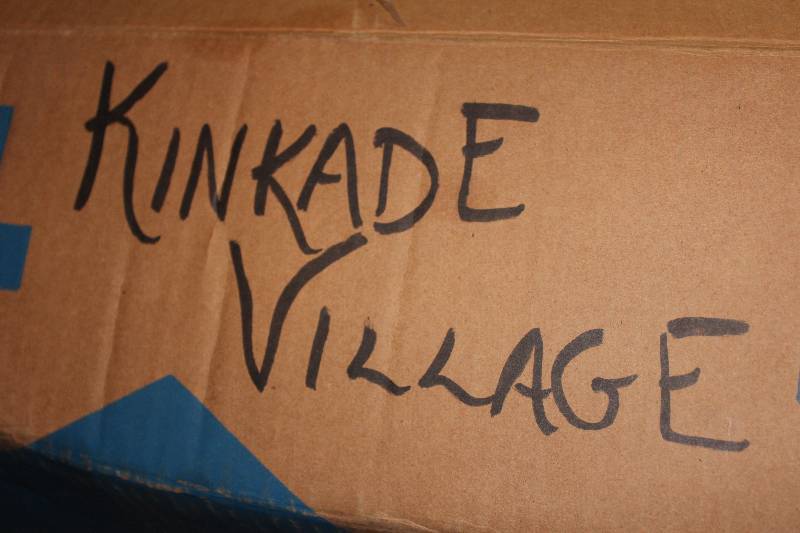 lot 82 image: Box Lot of Kinkade Village Holiday Decorations.