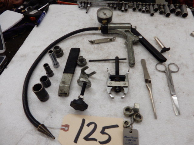 lot 125 image: Misc. items.. Including A Vacuum Pump, Battery Terminal tool, Wiper Arm..Misc. Tools and sockets