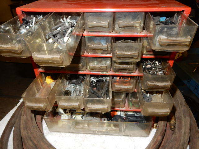 lot 7E image: 2, 25ft Air hoses.  Cabinet with 25plastic drawers and a larger bottom drawer. Contents included.