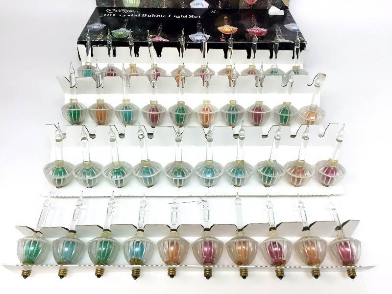 lot 6 image: Four boxes of Noma 10 crystal bubble lights that can screwed into vintage plastic electric candelabras or any candle holder highly collectible