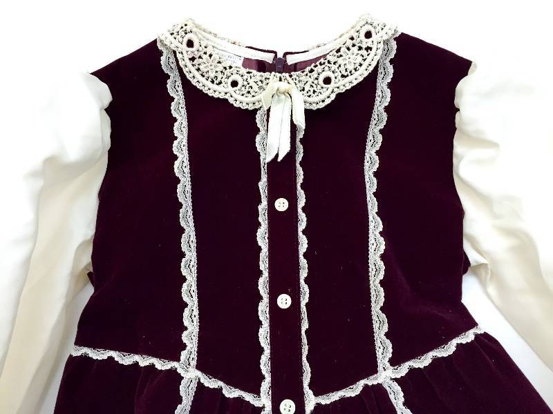 lot 25 image: Two vintage childrens dresses Christmas one Burgundy velvet with white lace the other a beautiful blue and green plaid with gold stripes and white lace accents