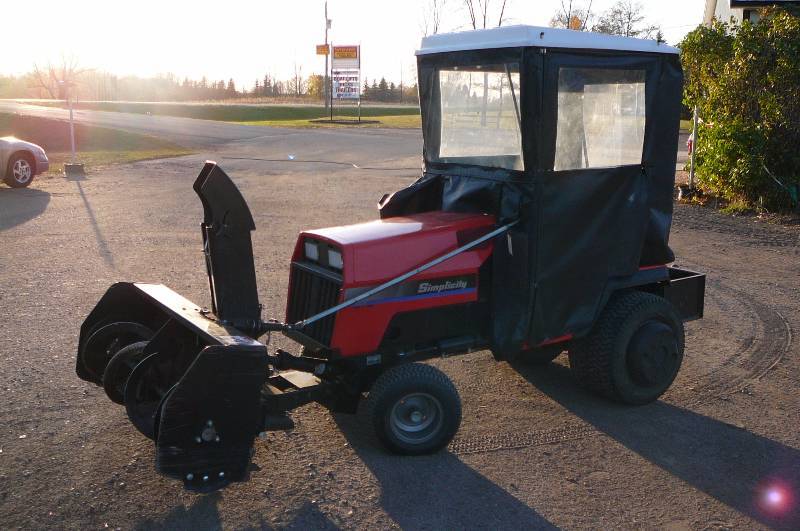lot 73 image: Simplicity Sun star Hydro 20hpv twin Kohler engine Power steering power lift 60 Deck 46 two stage snow blower wheel weights rear box new cutting edge tier chains extra blades new skids for blower cab rear hitch 552.9 hours Runs and works